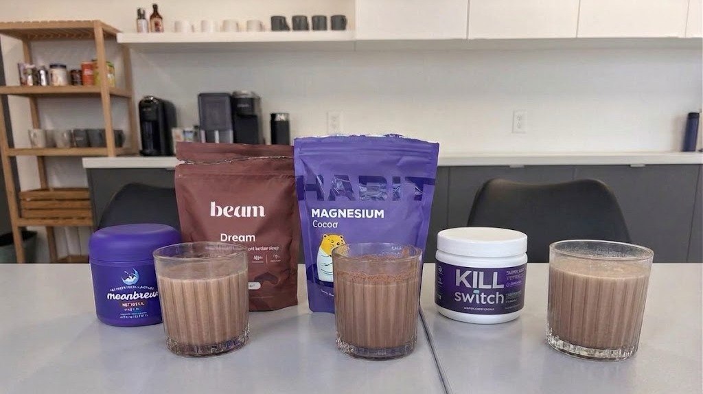 Four sleep cocoa products from MoonBrew, BEAM Dream, HabitONE and SWITCH Killswitch arranged with prepared cocoa drinks